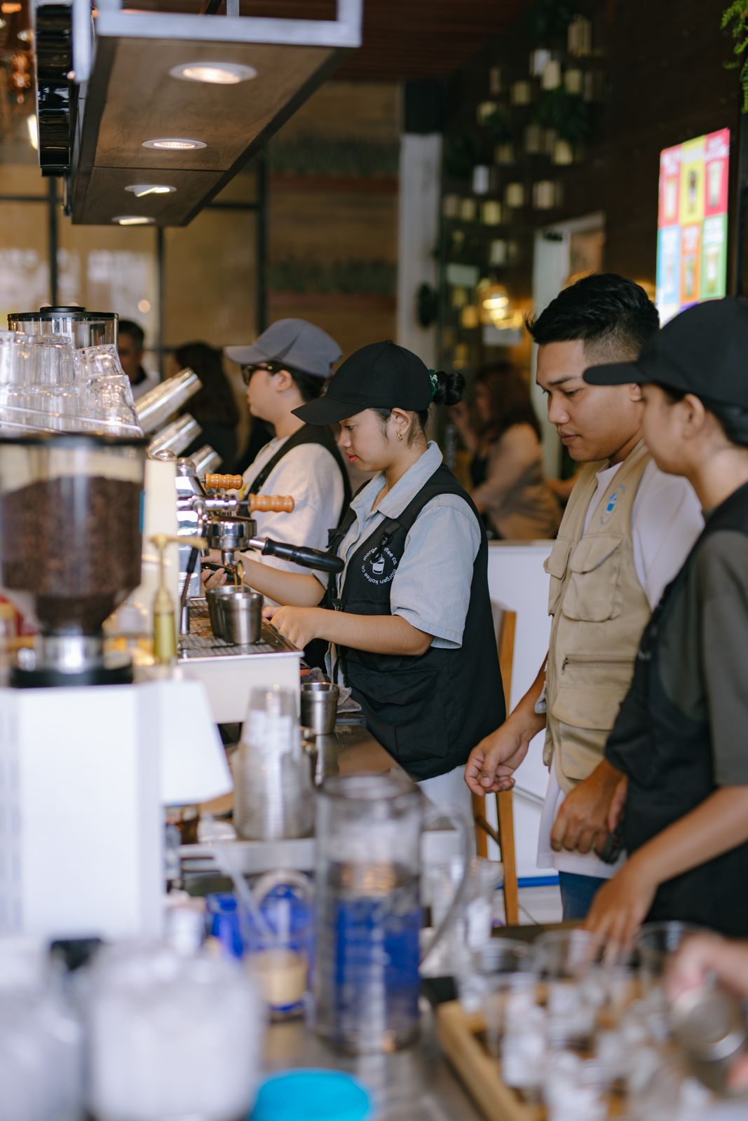 Baristas pulling shots at the espresso machine