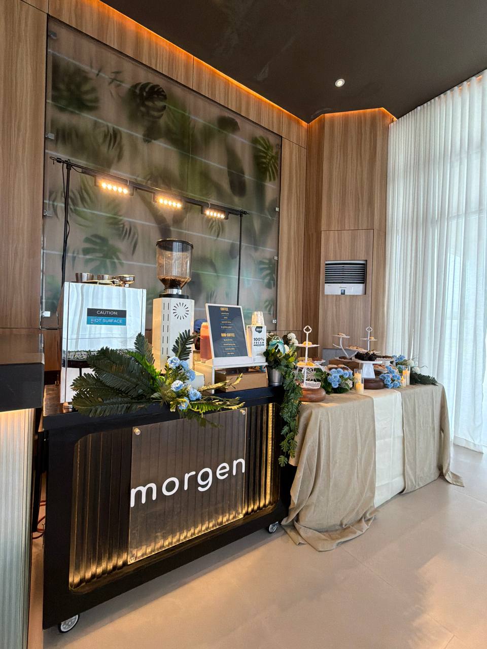 The Morgen cart in a black and gold finish set up beside a dessert spread at an indoor event