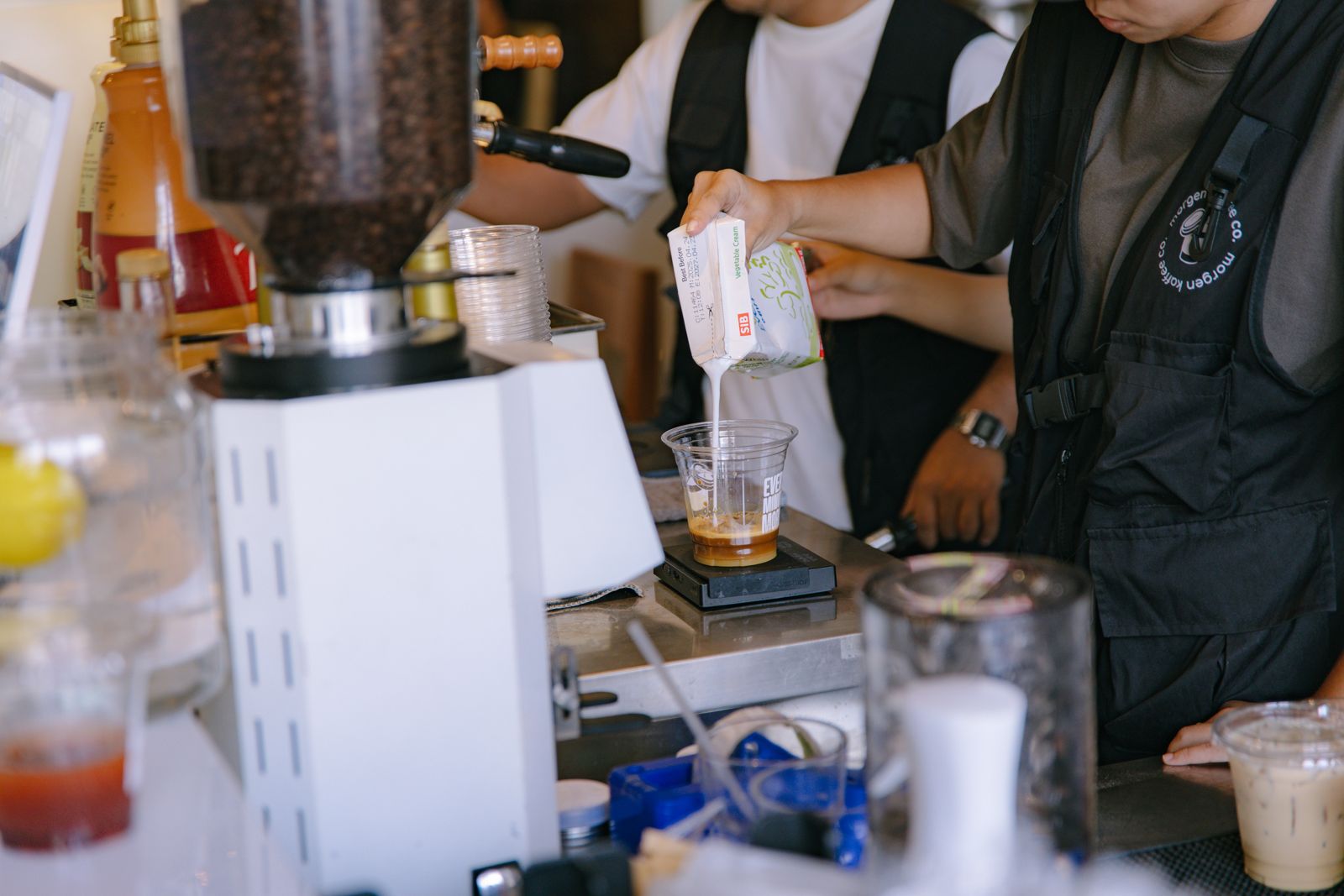 A barista building drinks to order at an event