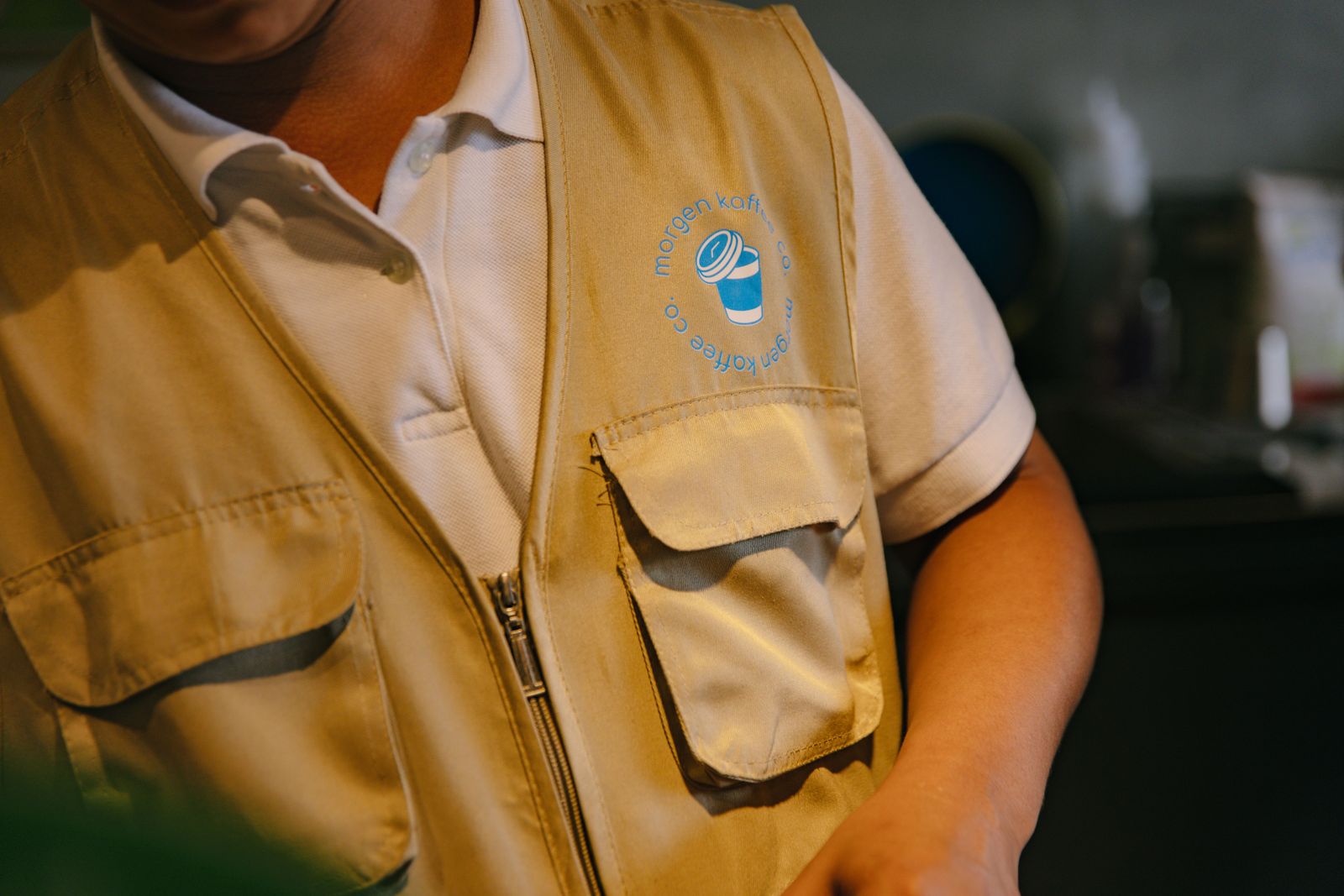 The Morgen cup-and-clock logo on a barista vest